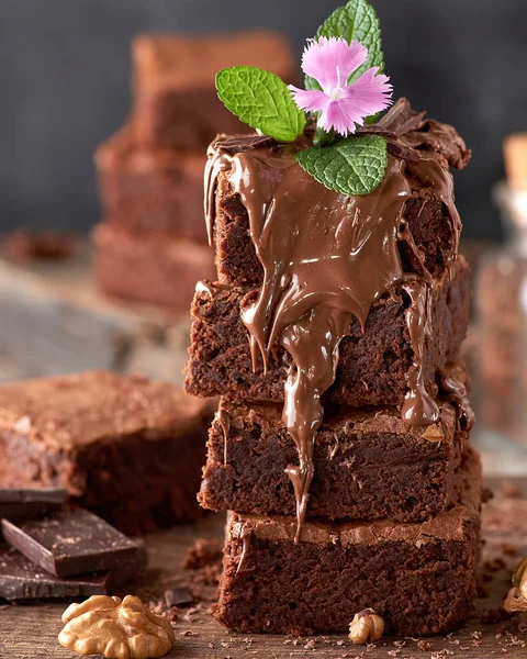 stack of square pieces of baked brownie chocolate poured on brow