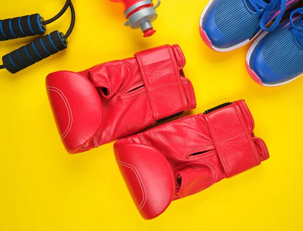 Pair of red boxing gloves and blue sneakers — Stock Photo, Image