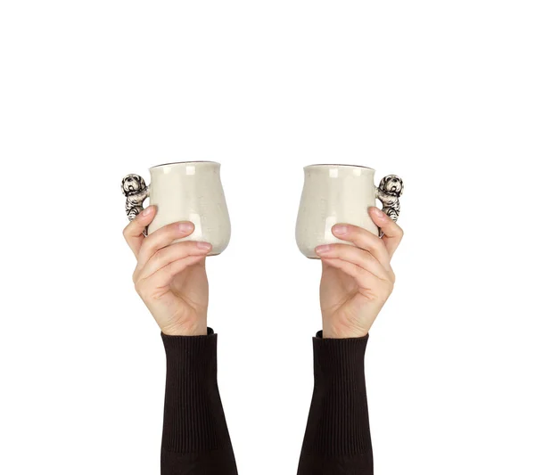 Gray ceramic cup in female hand on a white background, hand rais — Stock Photo, Image