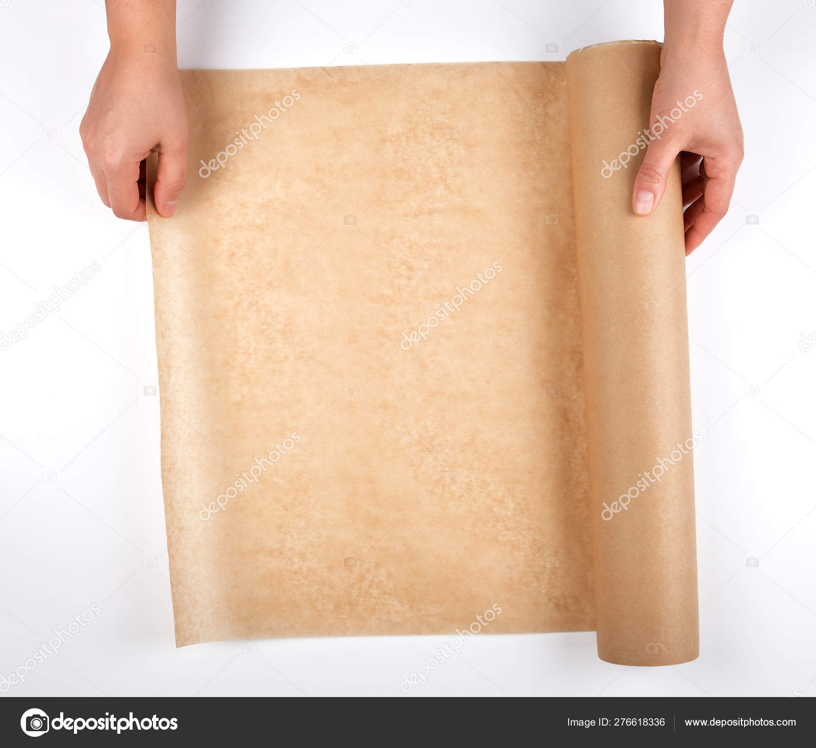 Roll of brown parchment paper for baking food in female hands