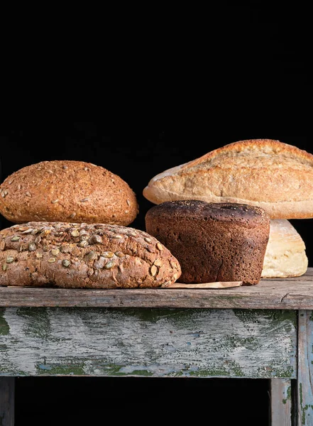 baked various breads , black  background