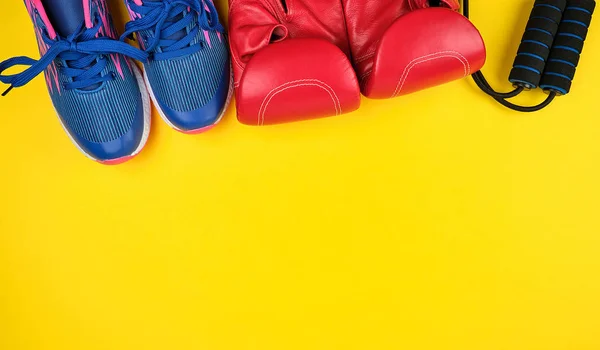 Paire de baskets bleues, gants de boxe en cuir rouge — Photo