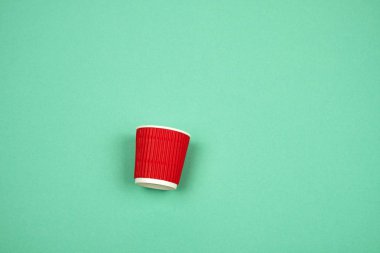 yeşil bir ba sıcak içecekler için oluklu kenarları ile kırmızı kağıt fincan