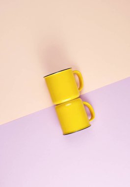 soyut bir pastel sırt bir kolu ile iki sarı seramik bardak