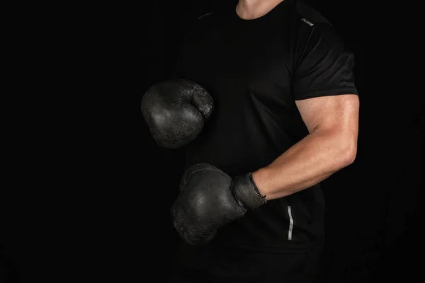 Young man stands in a boxing rack, wearing very old vintage blac — Stock Photo, Image