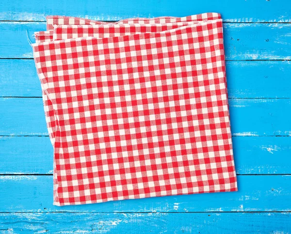 white red checkered kitchen towel on a blue wooden background