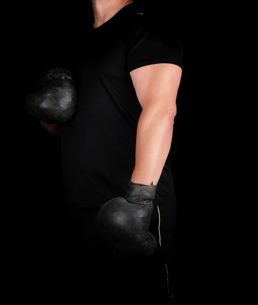 Young man stands in a boxing rack, wearing very old vintage blac — Stock Photo, Image