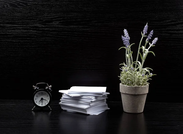 stack of white square note papers, a ceramic pot of lavender and