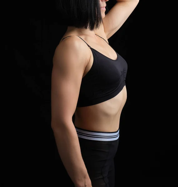 Body of a girl of athletic appearance in a black bra and legging — Stock Photo, Image