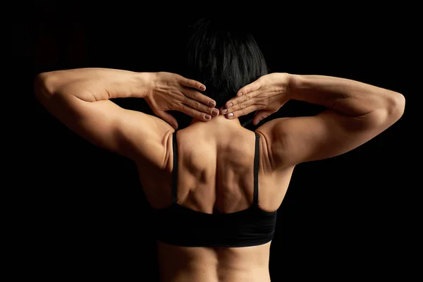 young athletic girl with black hair turned her back and showing