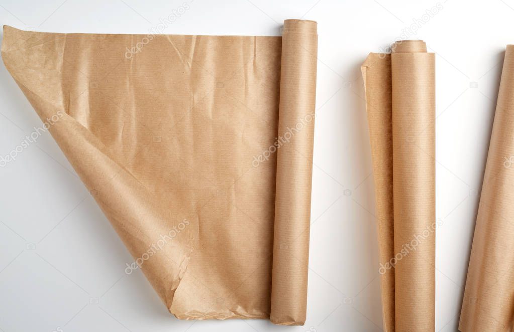 rolled rolls of parchment baking paper on a white background
