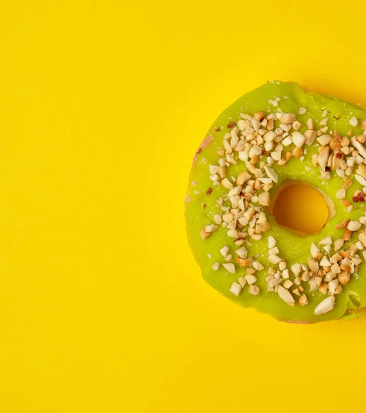 round sweet green pistachio donut sprinkled with ground nut