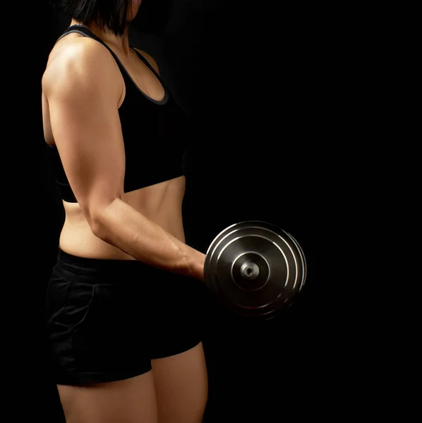 young woman of Caucasian appearance holds steel type-setting dum