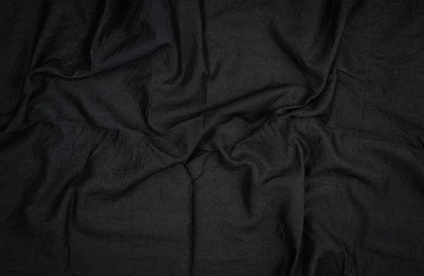 Fragment of black cotton fabric with waves, full frame — Stock Photo, Image