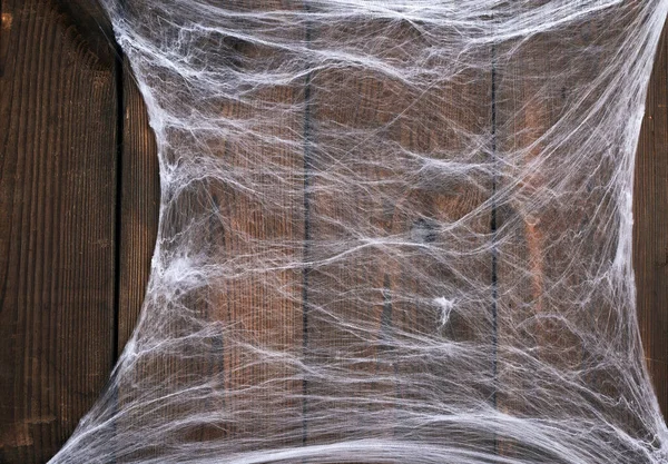 Kompozisyonun köşesinde beyaz örümcek ağı, gri ahşap b — Stok fotoğraf