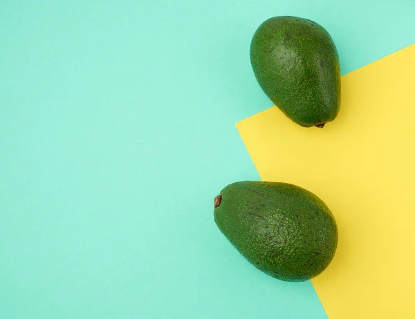 Two Green Avocado Fruits Green Yellow Background Top View Tasty — Stock Photo, Image