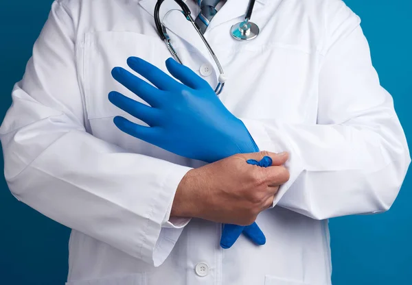 Arzt Weißer Uniform Zieht Seine Hände Mit Sterilen Blauen Latexhandschuhen — Stockfoto