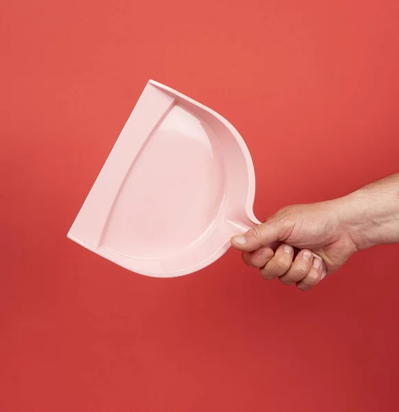 Male Hand Holds Pink Plastic Scoop Red Background Close — Stock Photo, Image