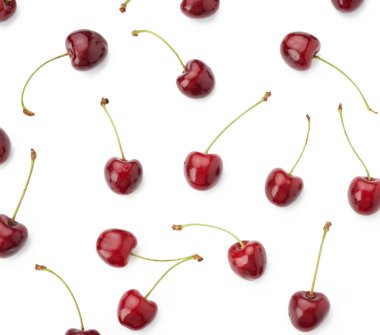 Olgun kırmızı, sulu, tatlı kirazlar beyaz bir arka planda izole, üst manzara, düz uzanmış