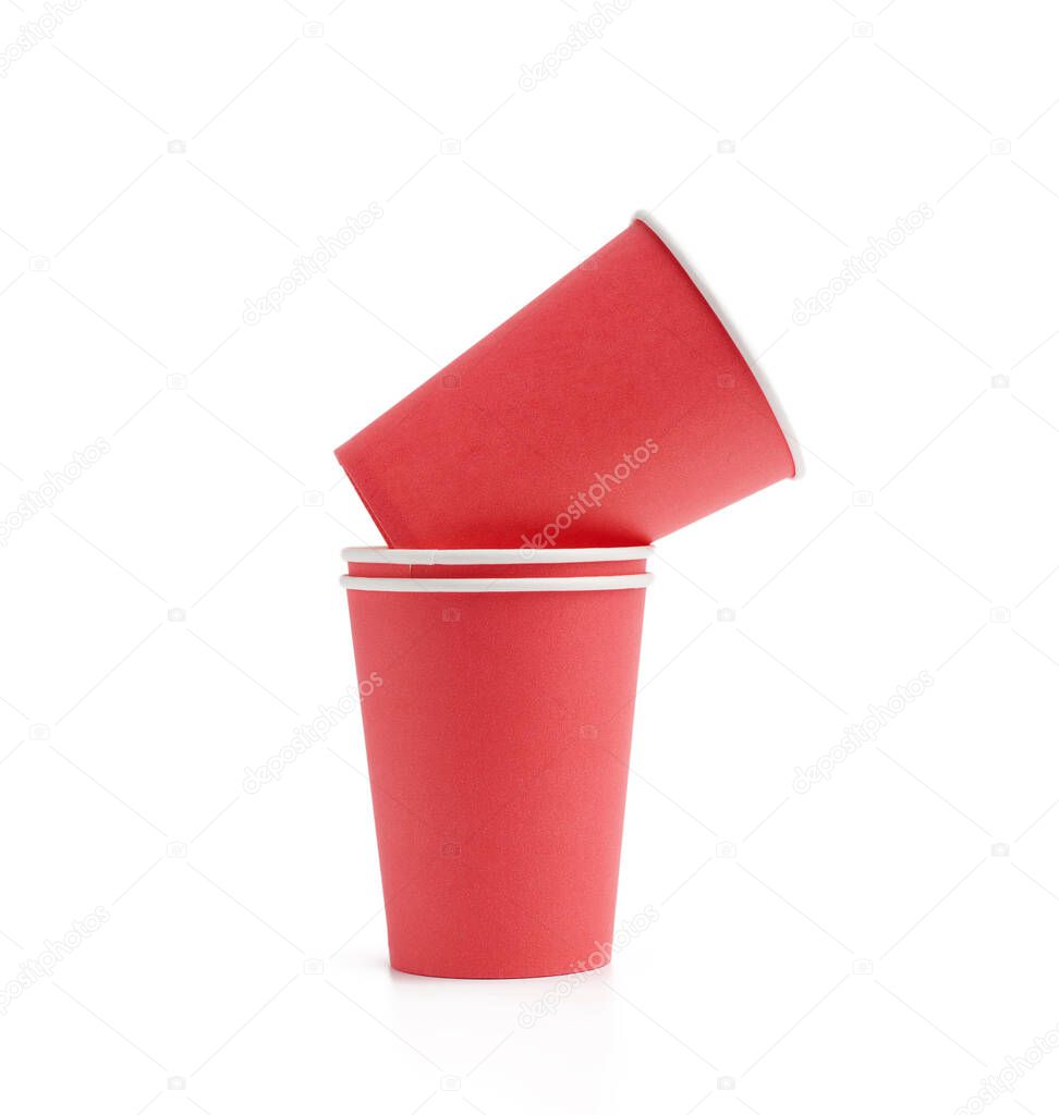 stack of red paper cups for hot takeaway drinks isolated on a white background. Plastic rejection concept, zero waste 