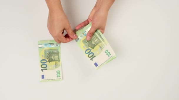 Beyaz Arka Planda Iki Kadın Eli 100 Euro Kağıt Para — Stok video