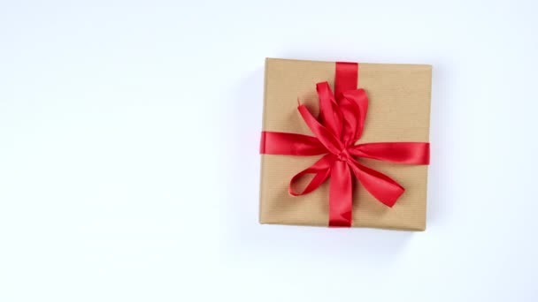 Female Hand Puts Gifts Packed Brown Kraft Paper White Table — Stock Video
