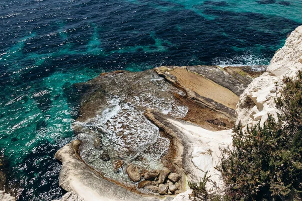 Beyaz kireçtaşı kayalıkları ve parlak turkuaz Akdeniz suları Marsaskala ve Marsaxlokk, Malta arasında kıyı şeridi boyunca