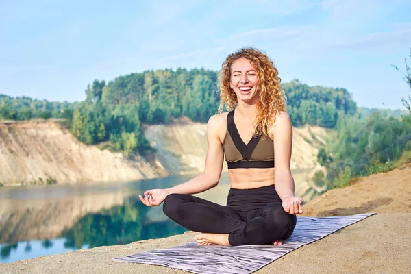 Oldukça neşeli Kızıl saçlı kıvırcık kadın gülüyor. Outddors. Kavram aşk yoga. Kavram aşk sabah.
