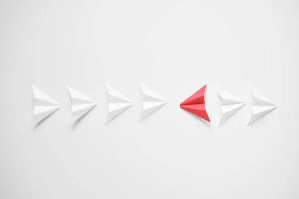 Stand out concept. Red paper airplane standing out from line of