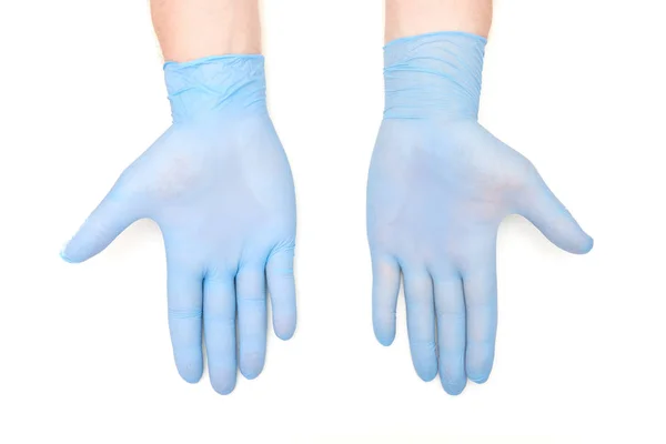 Mãos em látex azul luvas cirúrgicas mostrando palmas nas costas brancas — Fotografia de Stock