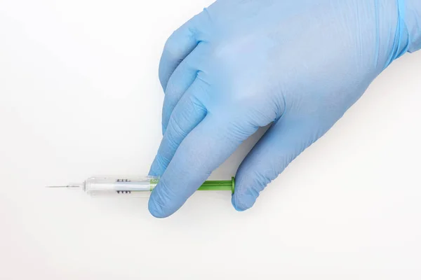 Hand in latex glove holding a syringe of low molecular heparine, — Stock Photo, Image