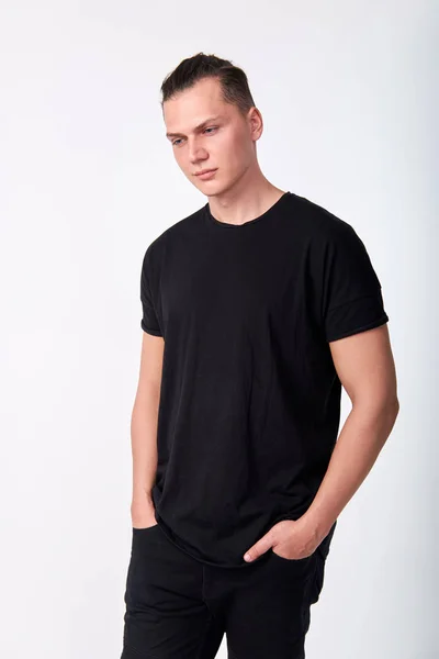 Portrait of attractive pensive young man wearing a black cotton — Stockfoto