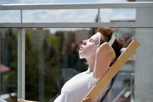 Relaxing Young Girl Stylish Hairstyle Sitting Balcony Applying Facial Mask — Stock Photo, Image