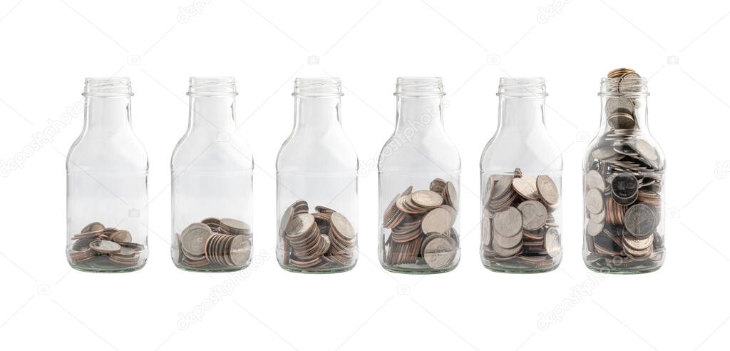 Collection of Thai baht coins in a white background glass bottle. Clipping path, Financial concept, Saving concept