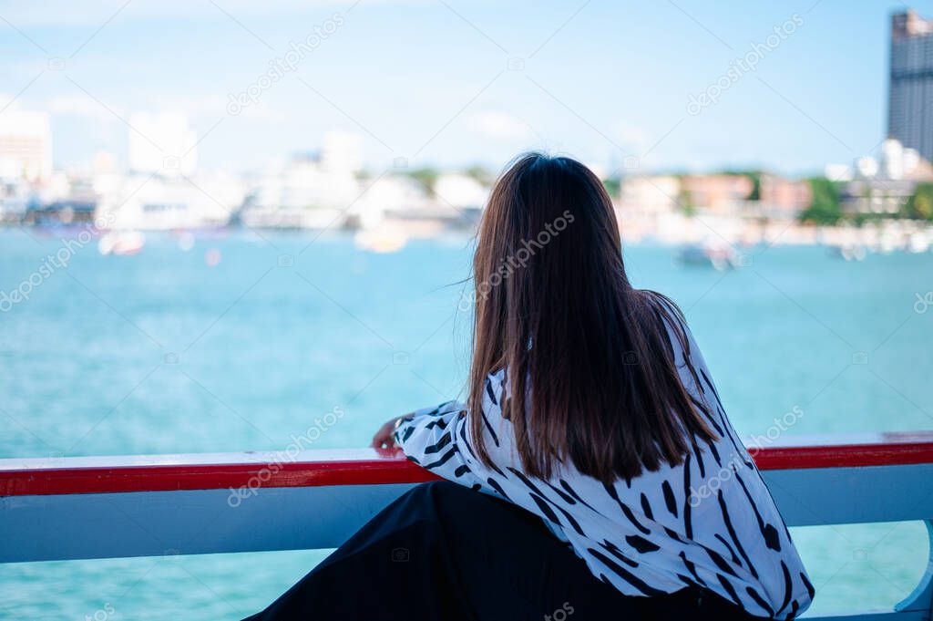 Thai women wearing a mask to prevent the outbreak of covid-19, A new normal tourism protection from the epidemic in 2020, Women sitting on a passenger boat floating on the sea, Concept of covid-19 pre