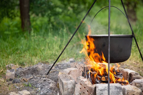 tehlikede bir kazan içinde yemek. Gıda açık havada tehlikede bir kazan içinde pişirilir