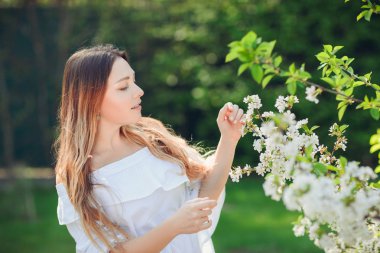 Romantik çiçeği bahar ağaçlar güzel zarif kadın portresi kapatın. çiçeklerle çevrili romantik ruh hali