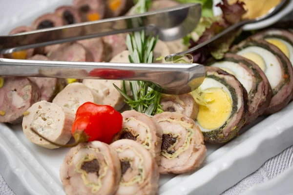 slicing of meat roll with the cherry tomato