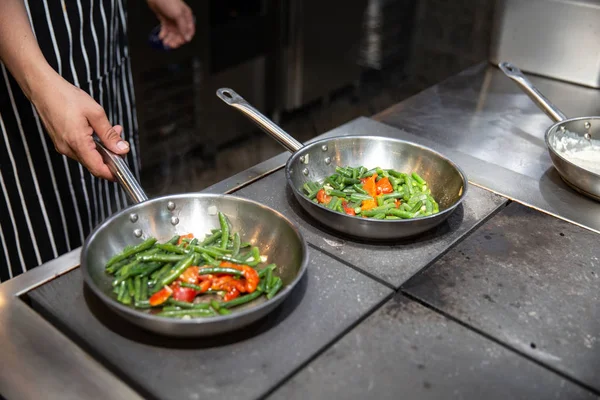 Izgara sebze hazırlanması işlemidir. Sebze ızgara tava üzerinde. Şef'in eller. kuşkonmaz ve profesyonel mutfak Bulgar biber