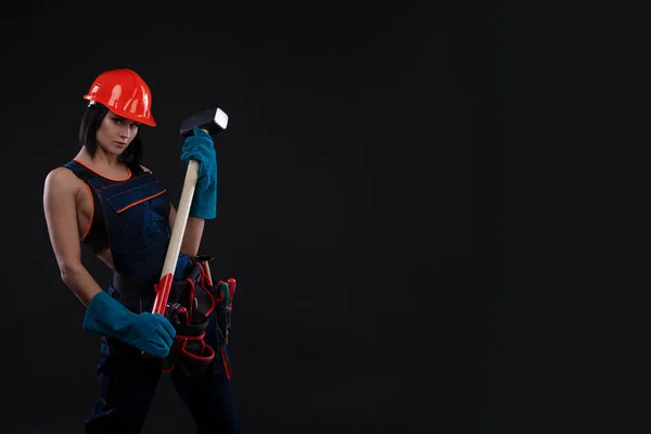 Sex equality and feminism. Sexy girl in safety helmet holding hammer tool. Attractive woman working as construction worker. gender equality. Copy space