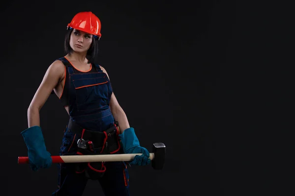 Sex equality and feminism. Sexy girl in safety helmet holding hammer tool. Attractive woman working as construction worker. gender equality. Copy space