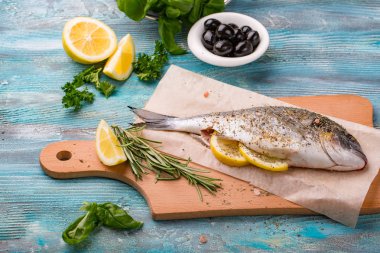 Taze balık dorado üstten görünüm. Ahşap tahta pişirme ıspanak ve limon sağlıklı gıda baharat