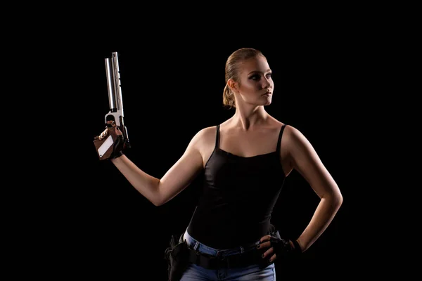 Military woman with a sport gun over black background. Shadow