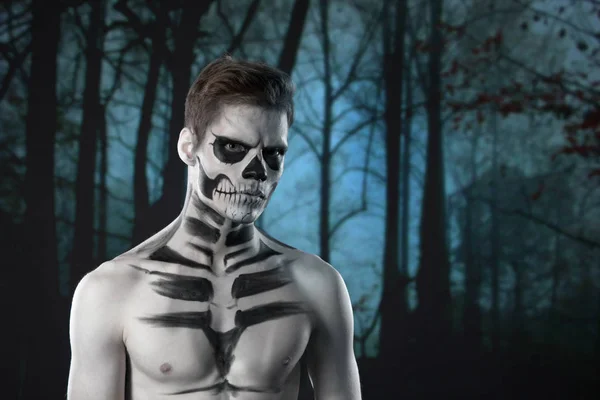 halloween scary skeleton man portrait in studio at dark forest