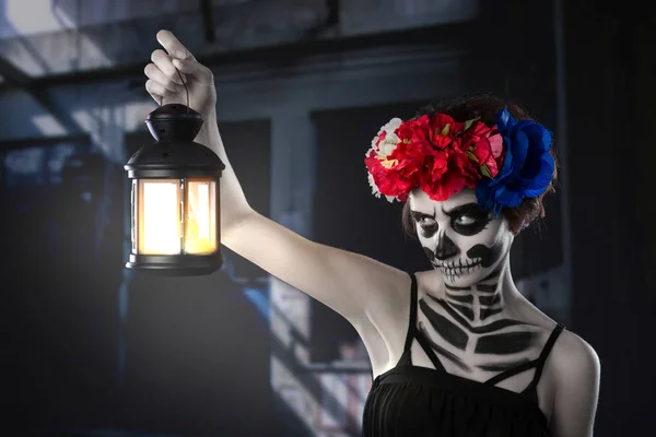 Halloween häxa. Vacker kvinna klädd i santa muerte mask gjutning spell nära glödlampa — Stockfoto