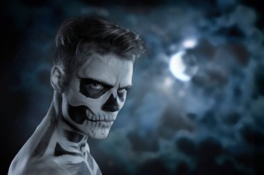 Dia de los Muerto kostüm - ölülerin günü Meksika tatildir. Kafatası yüz ve dolunay arka planı olan bir adam