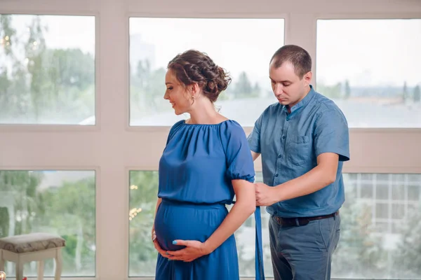 Couple Pregnant Woman Man Tying Ribbon Her Belly Husband Wife — Stock Photo, Image