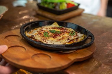 Lazanya fesleğen yaprağı ve tavada pişmiş peynir ile pişirilir. Hizmet