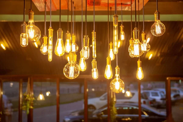 Many of Decorative light lamp bulb glowing on the ceiling - Cool light - gold tone