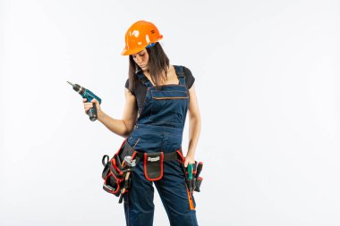 Evde çalışma için matkap ve bazı güç araçlarını kullanarak toolbelt olan kadın. Düz beyaz arka plan üzerinde remodeling çalışan kız. Bina, onarım ve yenileme.
